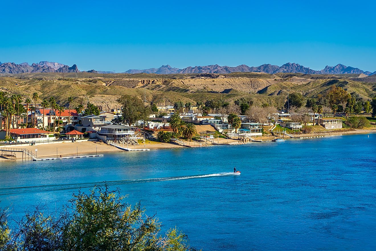 A jet skier speeds by riverfront property on the Colorado River in Bullhead City, Arizona.