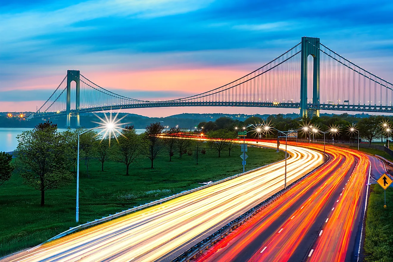 Verrazano Narrows Bridge above the light trails of the Belt Parkway traffic, at dusk. Credit: Mihai_Andritoiu / Shutterstock