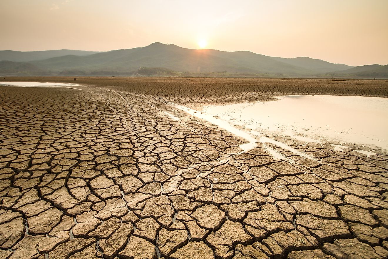 Cracked, dry lakebed caused by extreme heat and drought, illustrating the impact of climate change during summer.