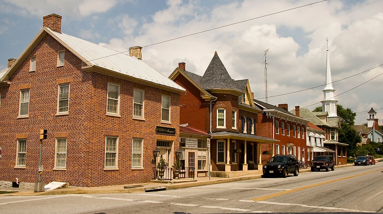 Street view of downtown Funkstown, Maryland, featuring historic brick buildings, small businesses, and tree-lined sidewalks. By Acroterion, CC BY-SA 3.0, https://commons.wikimedia.org/w/index.php?curid=7275466