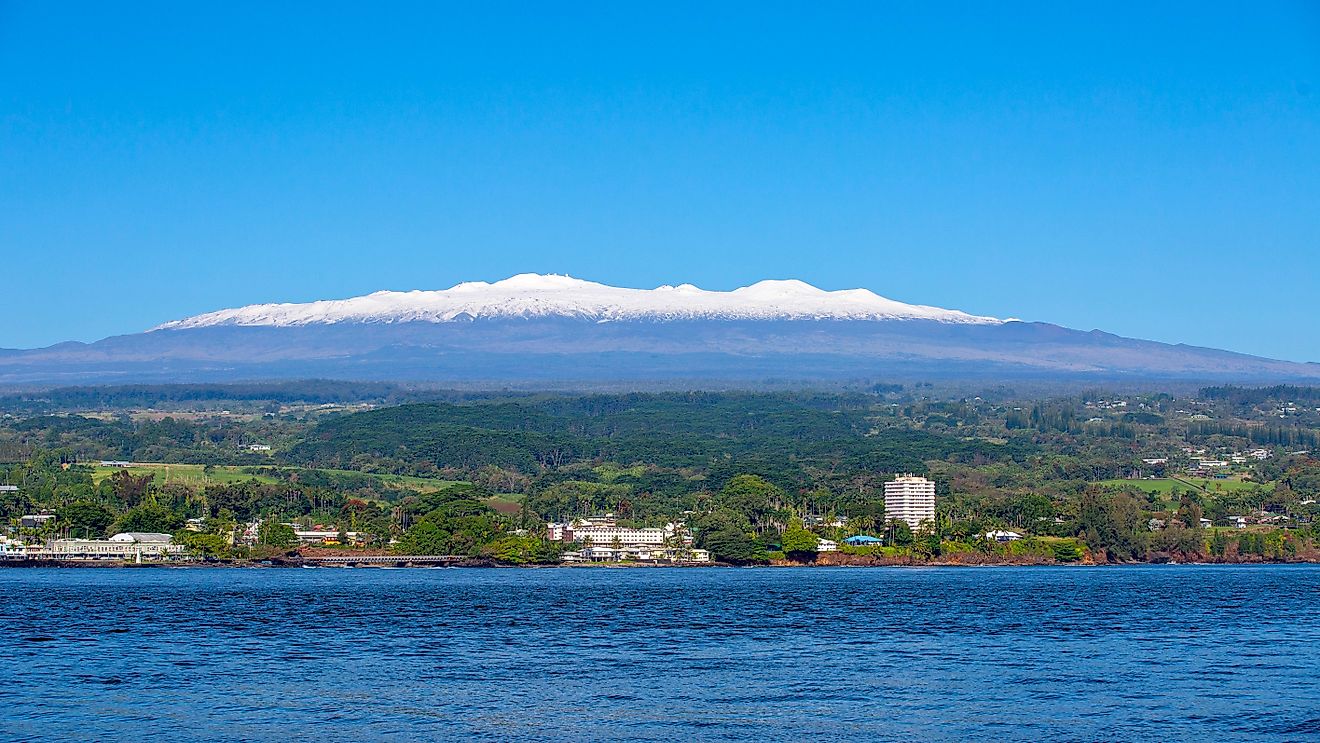 Picture of Hilo, Hawaii, on a sunny day with snow-capped Mauna Kea in the background.