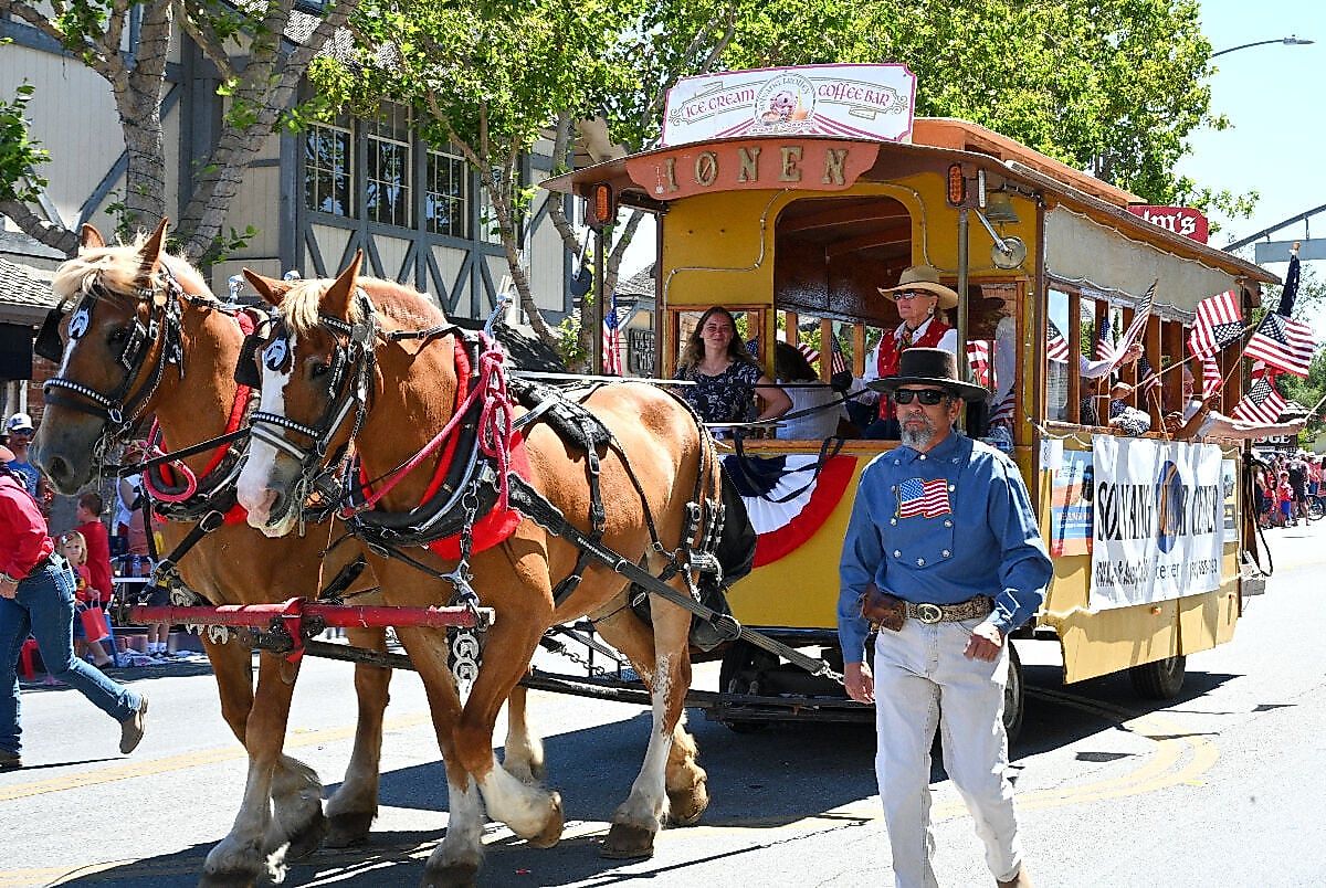The Solvang Senior Center participates in a horse trolly during the 4th of July parade. Photo:  Randy De La Pena
