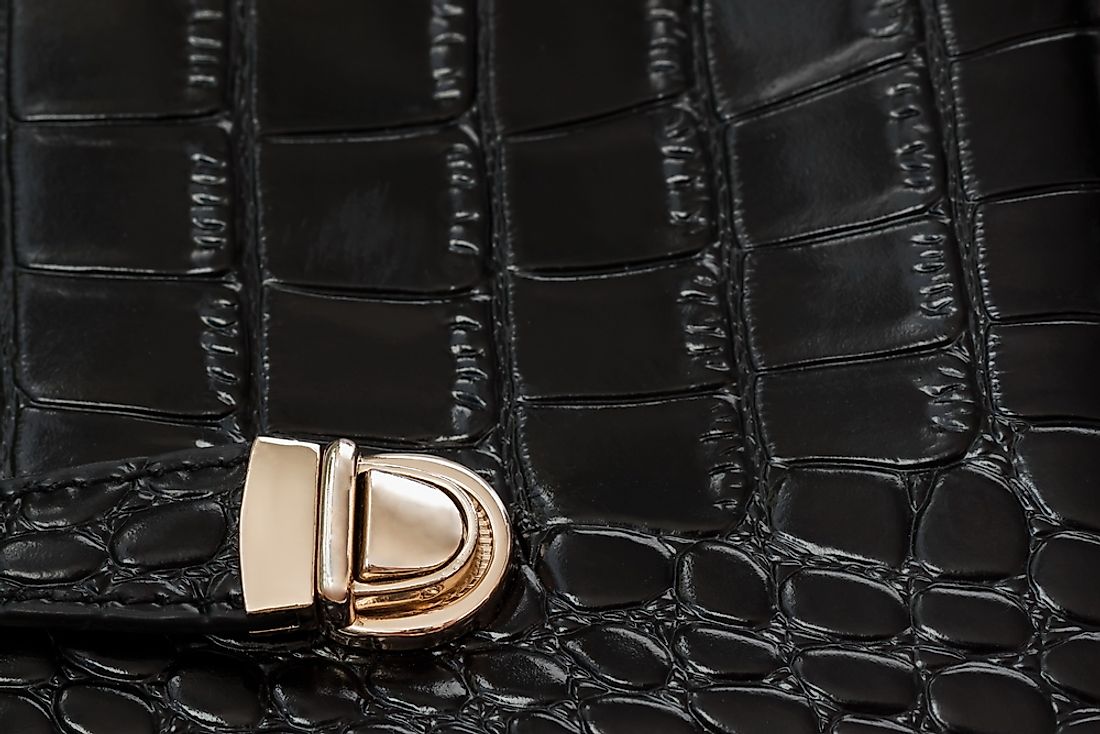 A black handbag made from repitl eskin. 