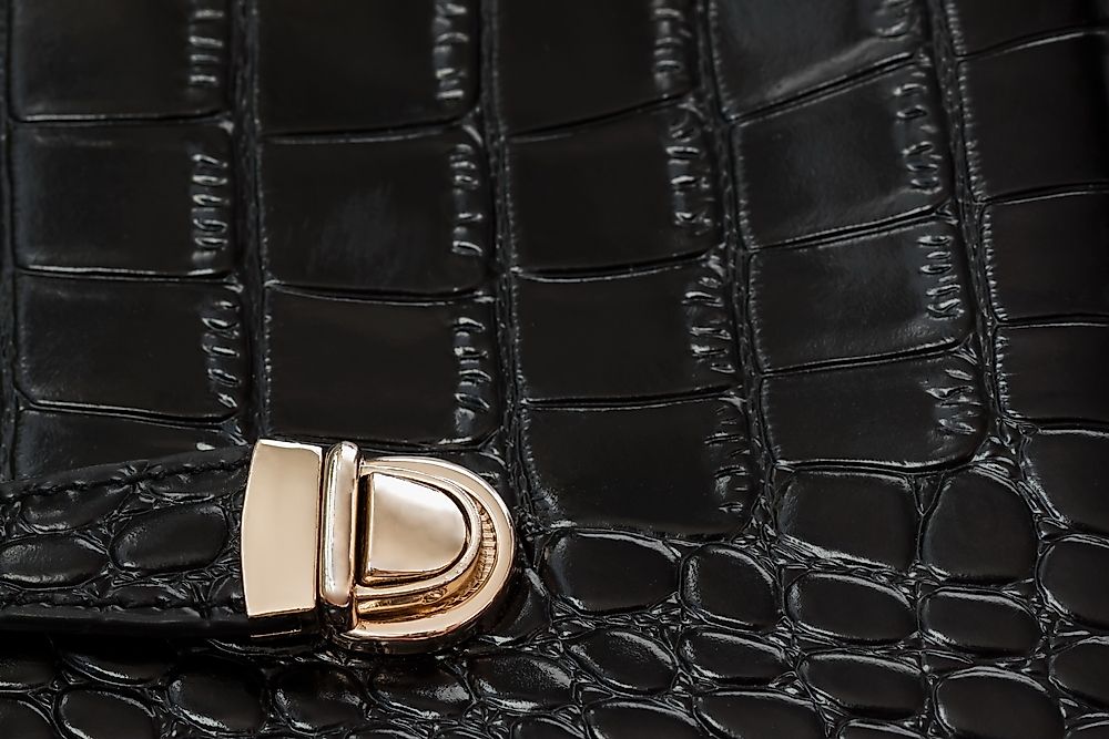 A black handbag made from repitl eskin.
