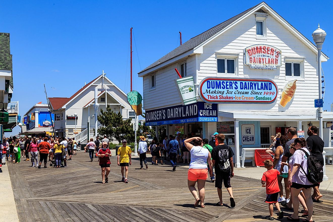 Stores, shops, and eateries attract visitors on the Ocean City boardwalk in Ocean City, Maryland, USA. Editorial credit: George Sheldon / Shutterstock.com