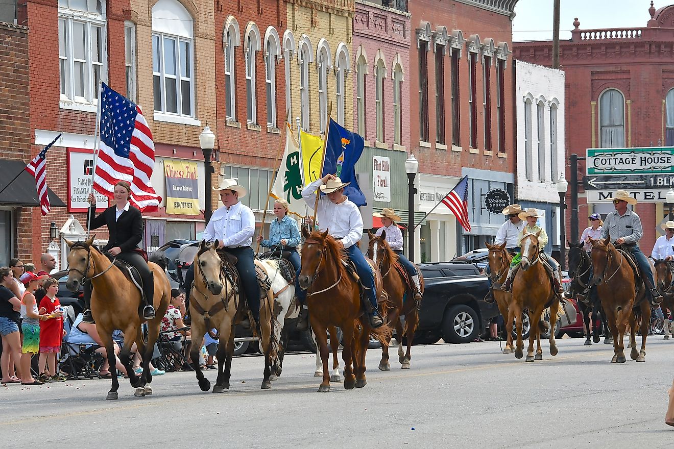 Local 4-H club members riding horses on Main Street in the Washunga Days Parade, Council Grove, Kansas. Editorial credit: mark reinstein / Shutterstock.com