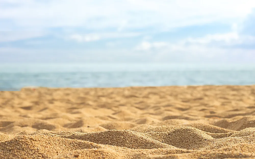 Sandy beaches get their color from the type of sediments that the beach is composed of. 