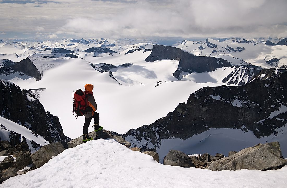 A mountain climber on the peak of Norway's highest mountain, Galdhøpiggen. 