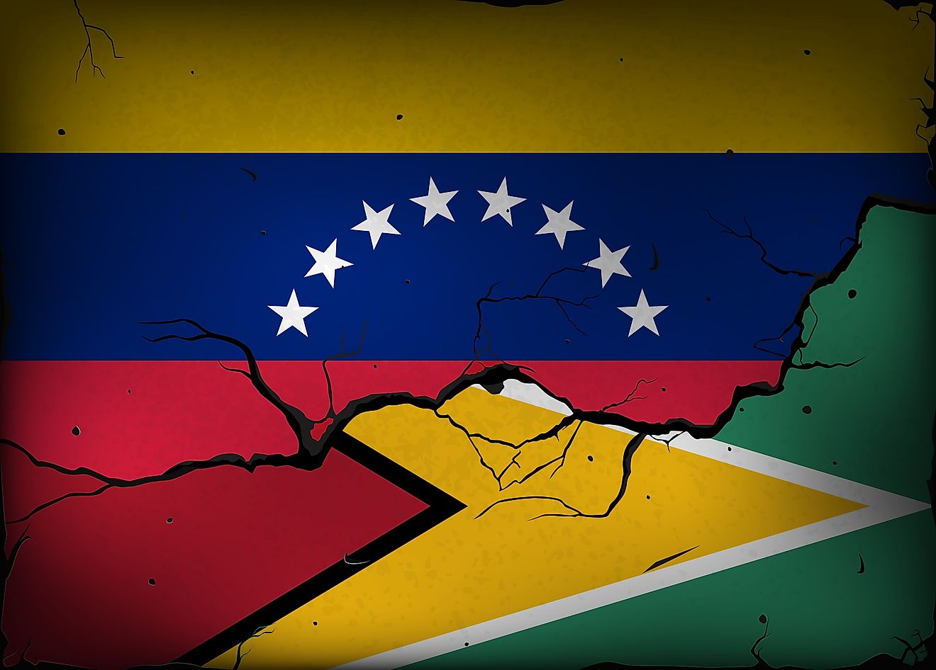 Flags of Venezuela and Guyana against a background of a wall with cracks. (Credit: Evgeny Simonov via Shutterstock)