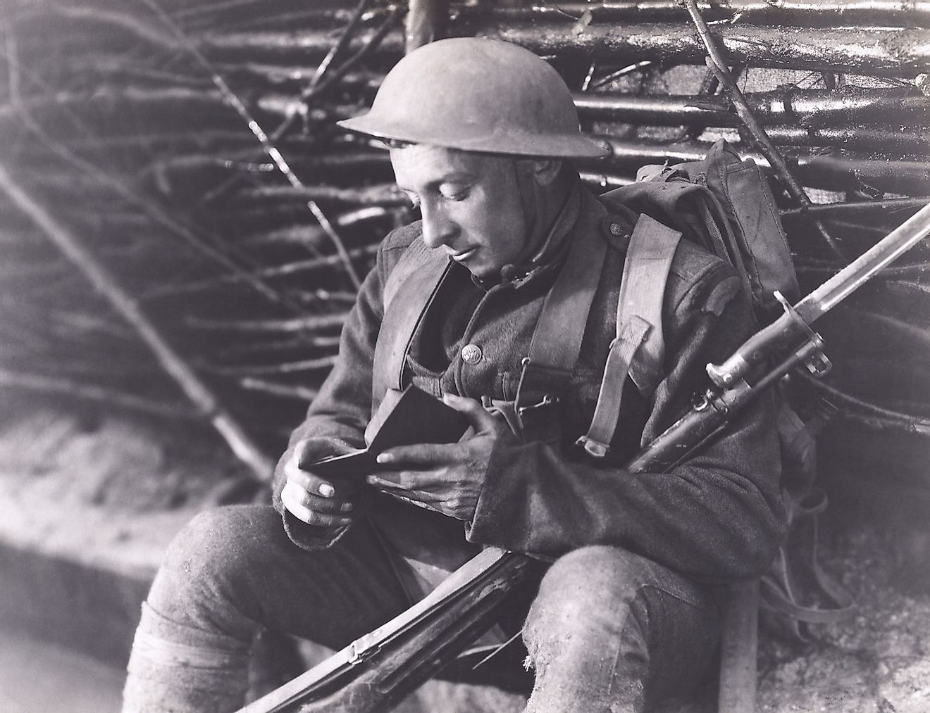 A World War soldier reading a book while posted at the warfront. Image credit: Everett Collection/Shutterstock.com