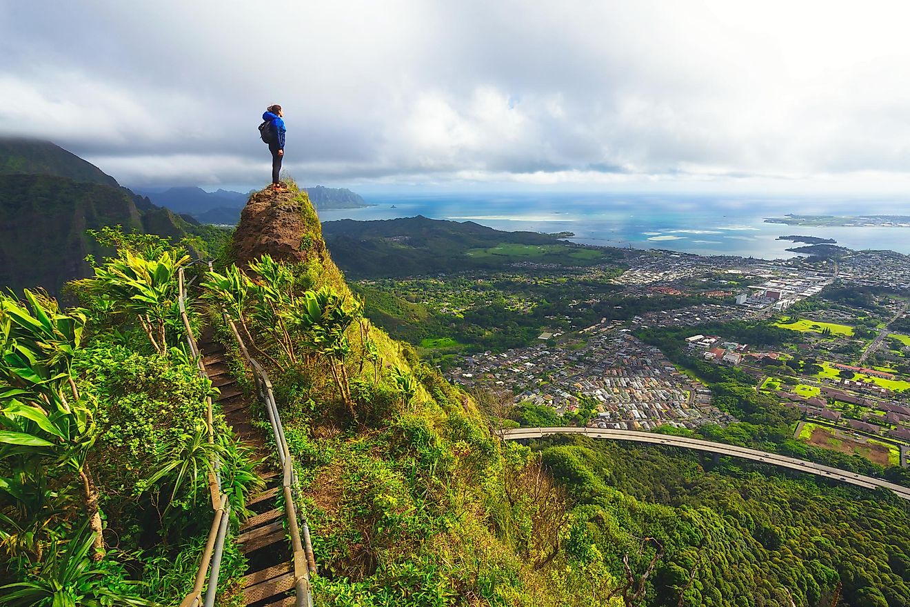 Hiker standing on top of a rock in Hawaii, one of the most exotically beautiful destinations in the US.