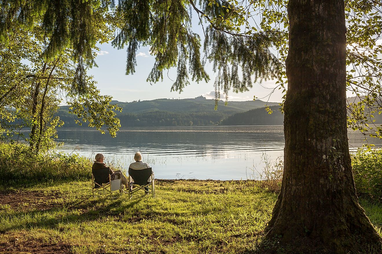 Seniors savoring a beautiful sunset by the shores of Cottage Grove Lake, Oregon, USA.