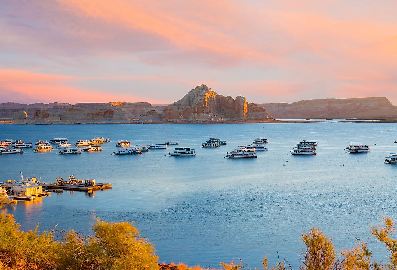 Houseboats during sunrise near Wahweap Marina on Lake Powell. Image credit Paul Brady Photography via Shutterstock.