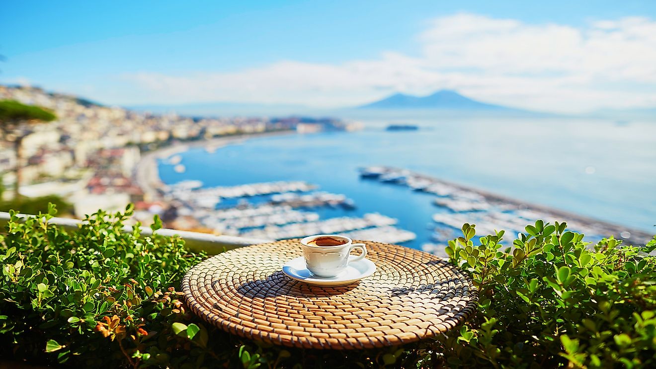 Cup of fresh espresso coffee in a cafe with view on Vesuvius mount in Naples, Campania, Southern Italy.