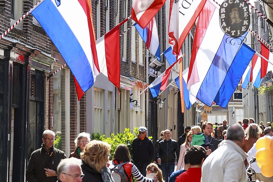 People walk down a street in Dorcrecht, the Netherlands. Editorial credit: TTStock / Shutterstock.com. 