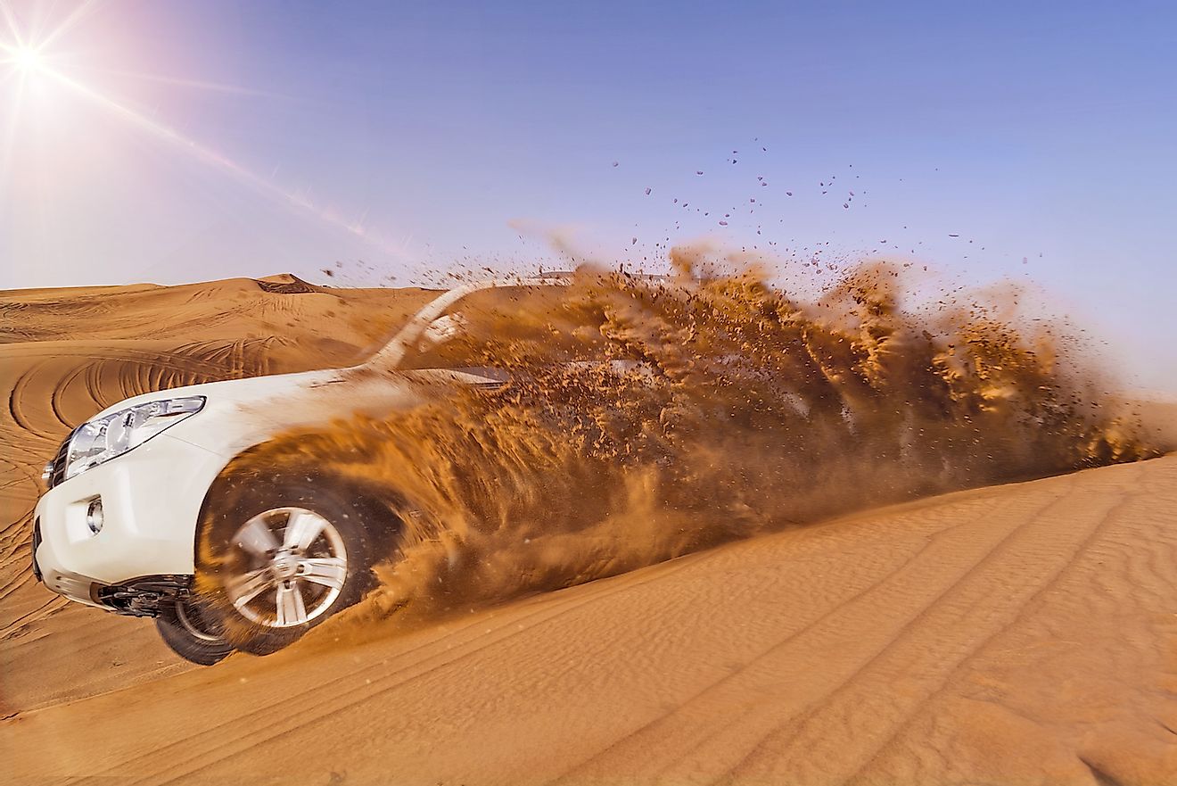 Offroad vehicle bashing through sand dunes in the desert. Image credit: PhoelixDE/Shutterstock.com