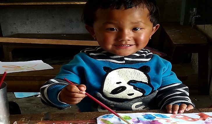 A Nepali child enjoys a painting session conducted by Trek to Teach. Photo credit of Trek to Teach.