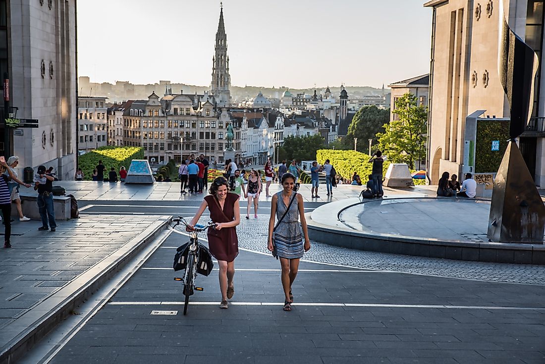 Two women walk through the streets of Brussels. Editorial credit: Werner Lerooy / Shutterstock.com.