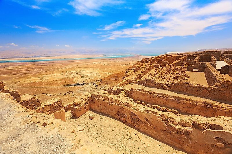 Masada fortress ruins atop a plateau bordering the outskirts of the Dead Sea.