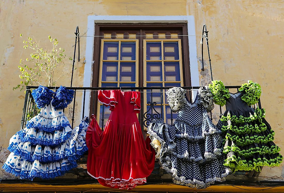 Traditional Spanish dresses hang from a balcony in Spain. 
