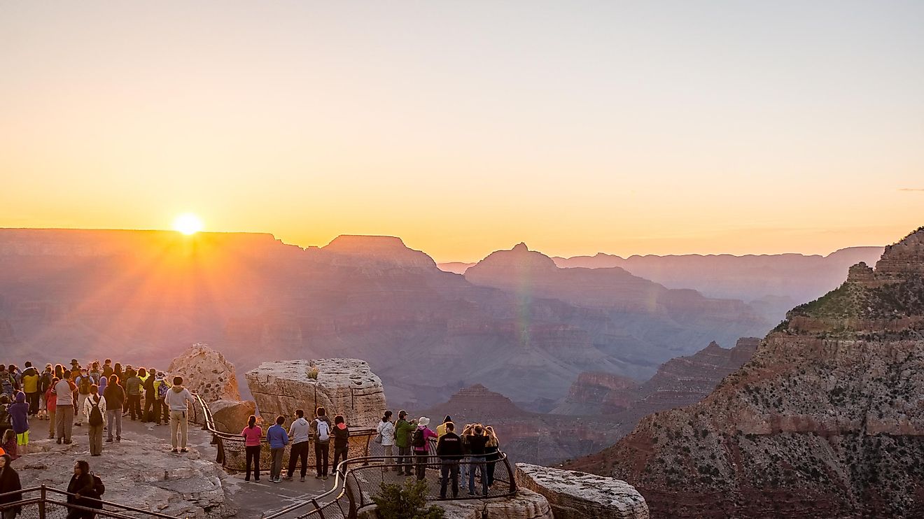 Visitors watching the sunrise from Mather Point in Grand Canyon.