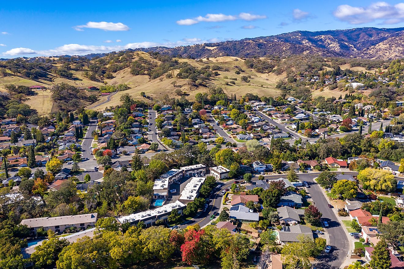 Drone photos over Vacaville, California, during the fall with colorful trees and hills.