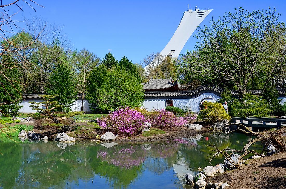 View of the tower of the Olympic Stadium rising into the sky behind the Botanical Garden in Montreal, Quebec. Editorial credit: meunierd / Shutterstock.com