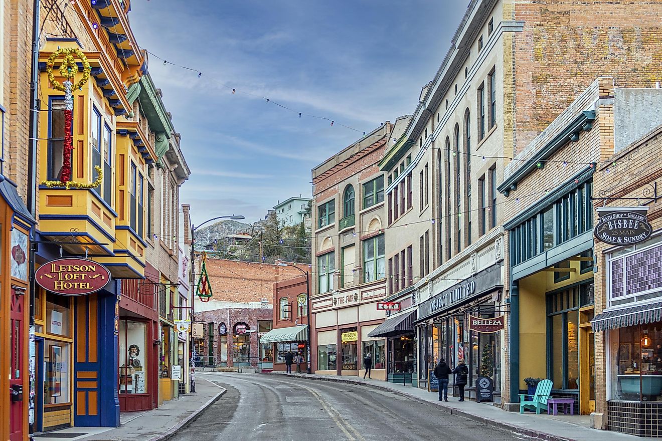 Buildings lining Main Street on a clear day at the edge of Bisbee, 