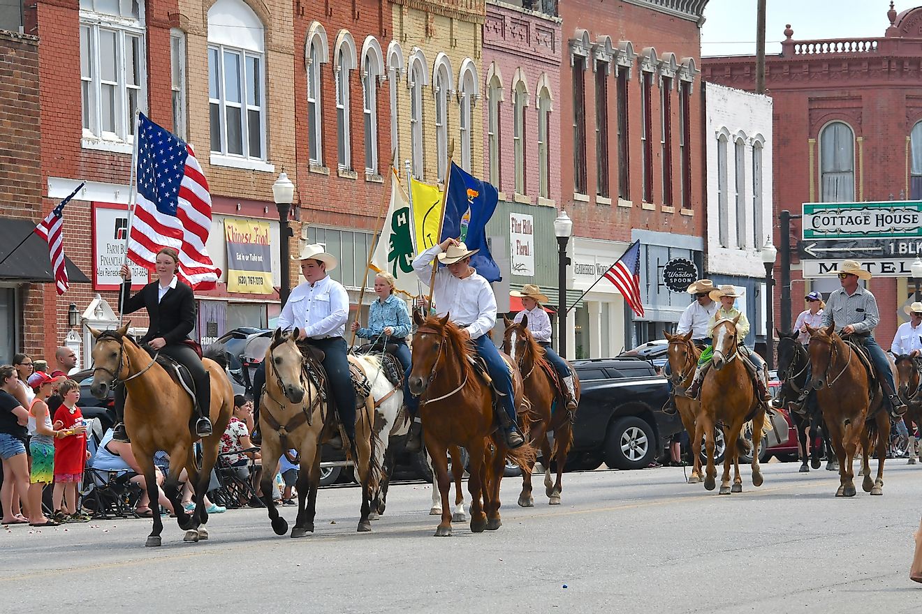 Members of the Local 4 H club ride their horses during the Washunga Days Parade in Council Grove, Kansas. Editorial credit: mark reinstein / Shutterstock.com
