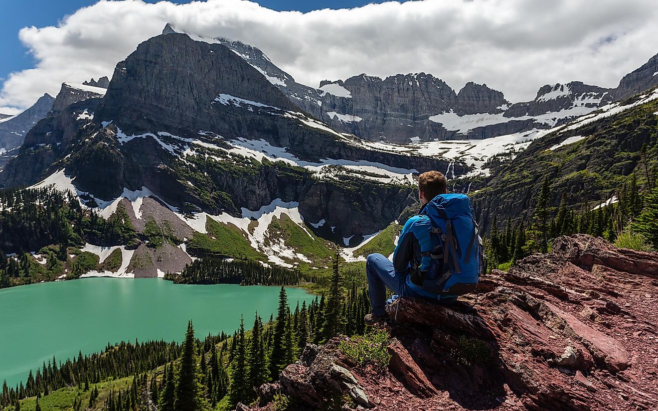 Hiker in Glacier National Park. View of Grinnell Lake. Image credit Stefan Wille via shutterstock