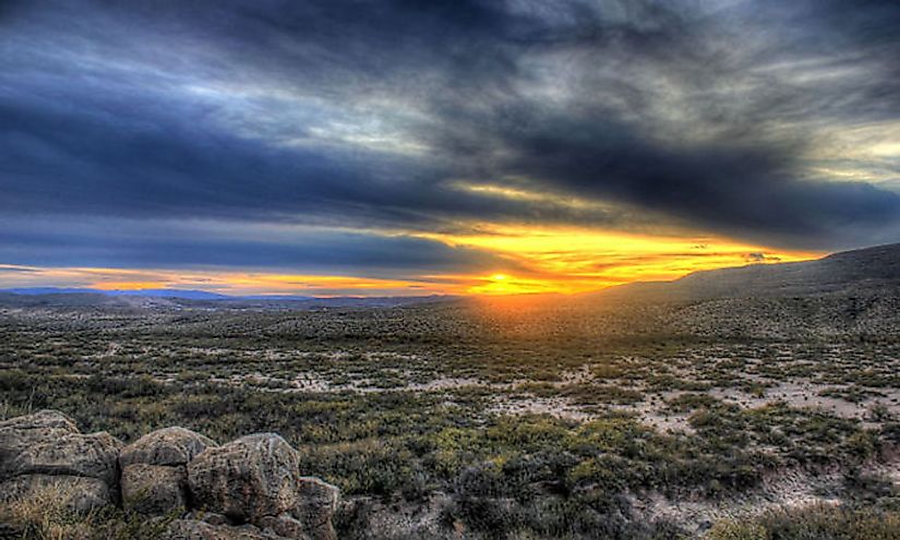 The sun setting behind the hills from Boquillas Canyon in the  Big Bend National Park.