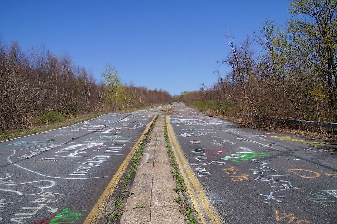 An abandoned road in Centralia, Pennsylvania that has been covered in chalk graffiti. 