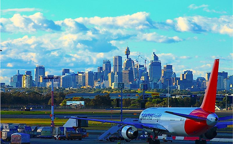 View from Kingsford Smith International Airport, Qantas plane with the Sydney cityscape in the background. Editorial credit: Eigenblau / Shutterstock.com.