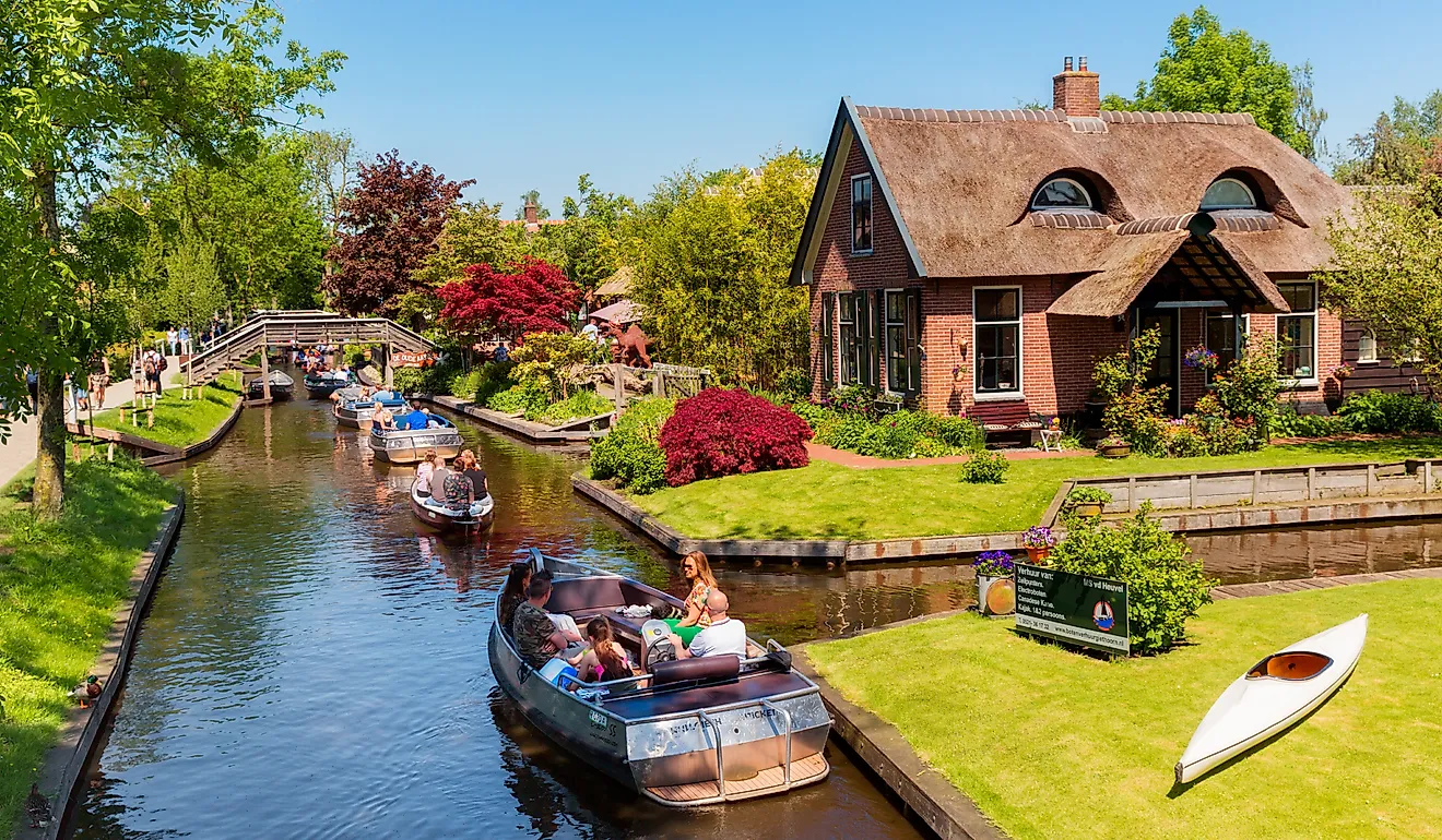 Boats filled with people along the canals in Giethoorn, Netherlands. Editorial credit: rob3rt82 / Shutterstock.com