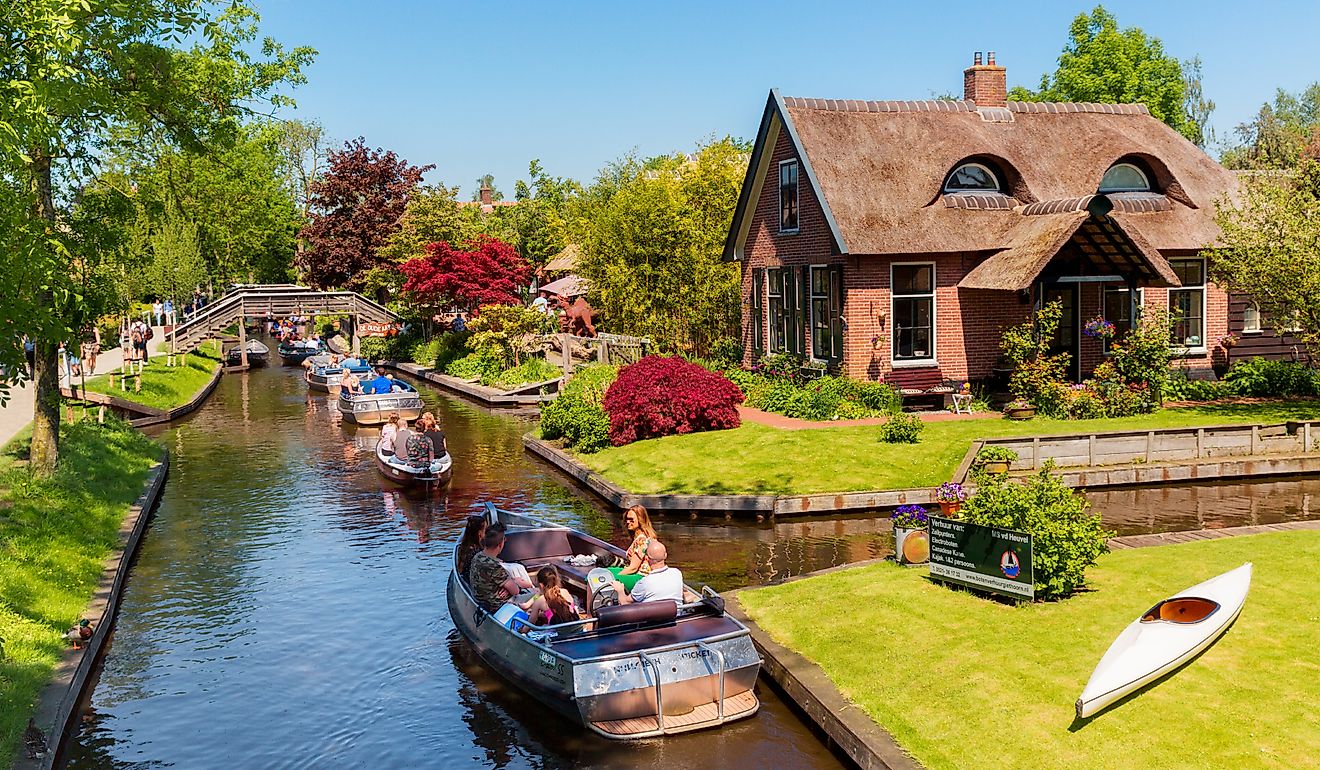  Boats filled with people along the canals in Giethoorn, Netherlands. Editorial credit: rob3rt82 / Shutterstock.com