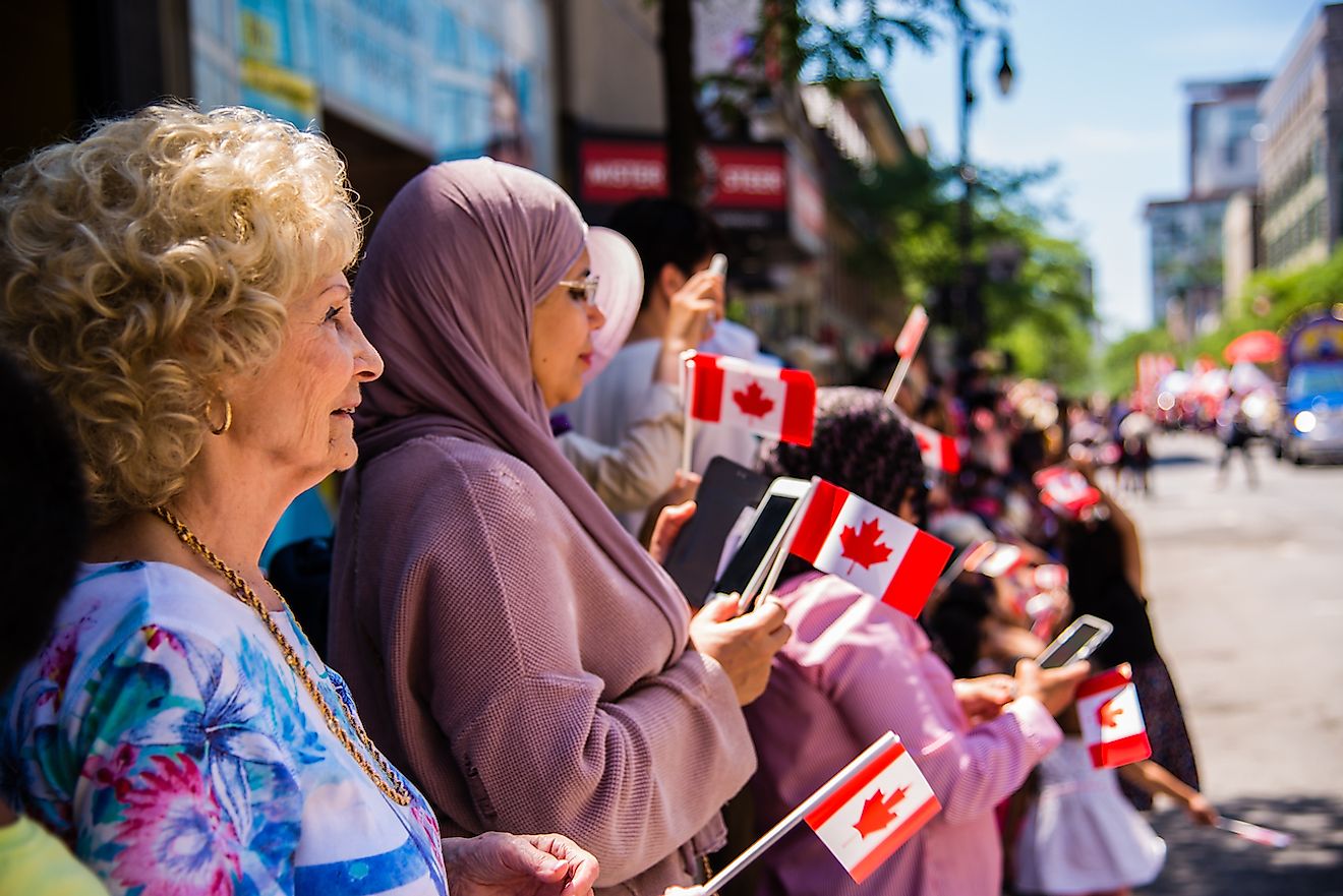 Canadians watching the Canada Day Parade. Image credit:  Vincent JIANG/Shutterstock.com