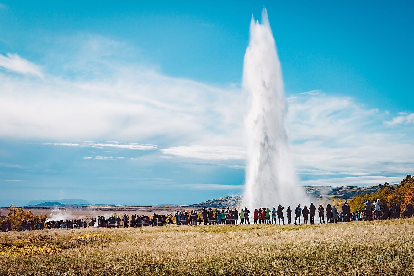 A crowd admiring an eruption of Stokkur geyser on Iceland. Image credit: Jakub Barzycki/Shutterstock.com