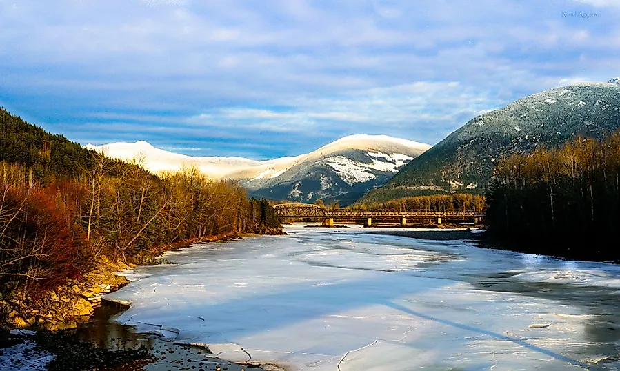 Mountain landscapes beyond the Finlay River in the wintertime.