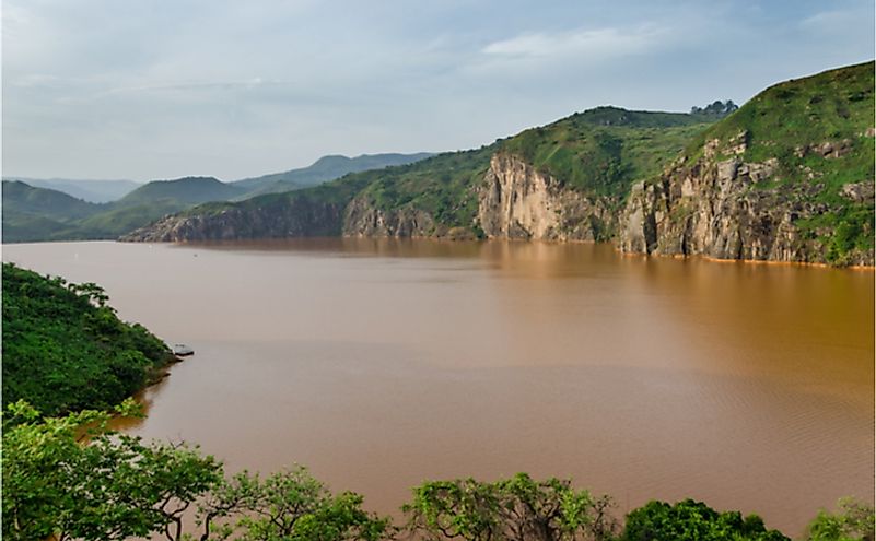The calm brown water of Lake Nyos, infamous for CO2 eruption with many deaths.