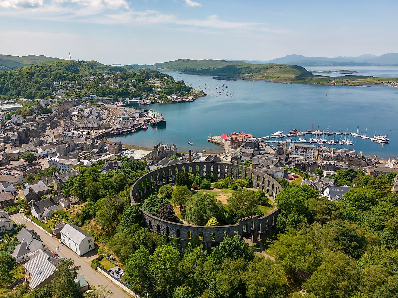 Aerial view of the Mccaig's Tower and Battery Hill in Oban, Scotland.