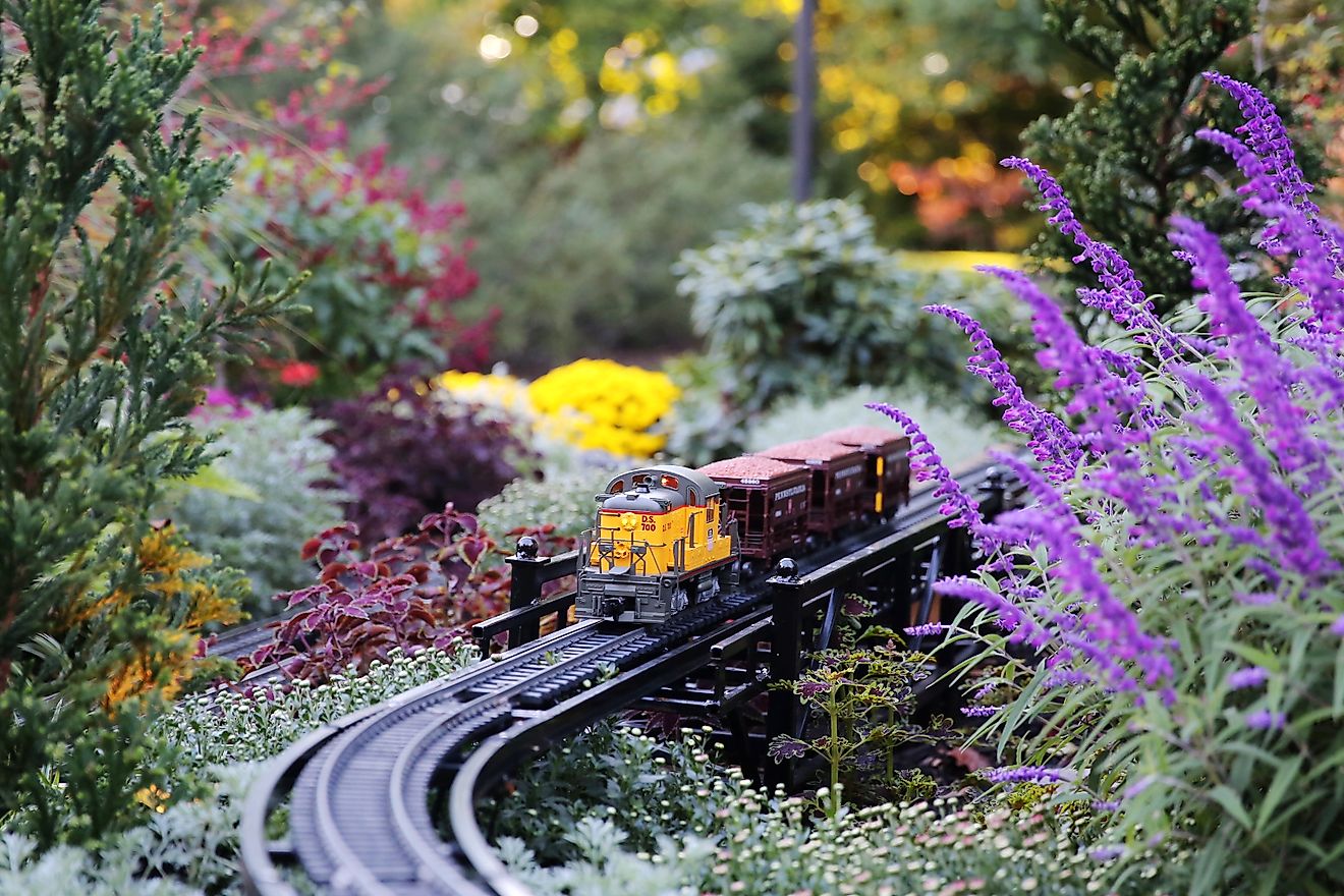 Model train set running through fall flowers in Longwood Gardens, Kennett Square, PA, USA
