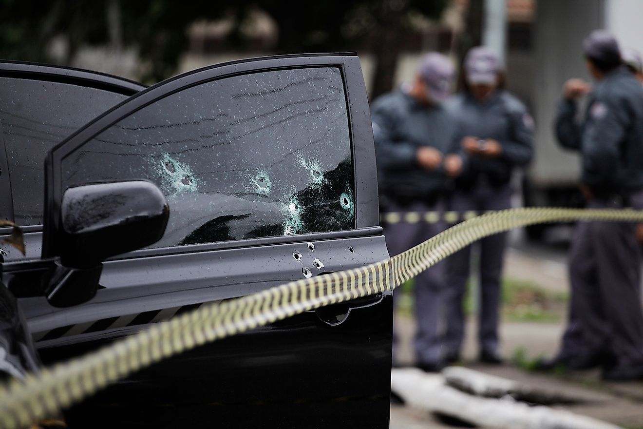 Bullet holes are seen in the window of a car after an armed robbery in Sao Paulo, Brazil. Image credit: Nelson Antoine/Shutterstock.com