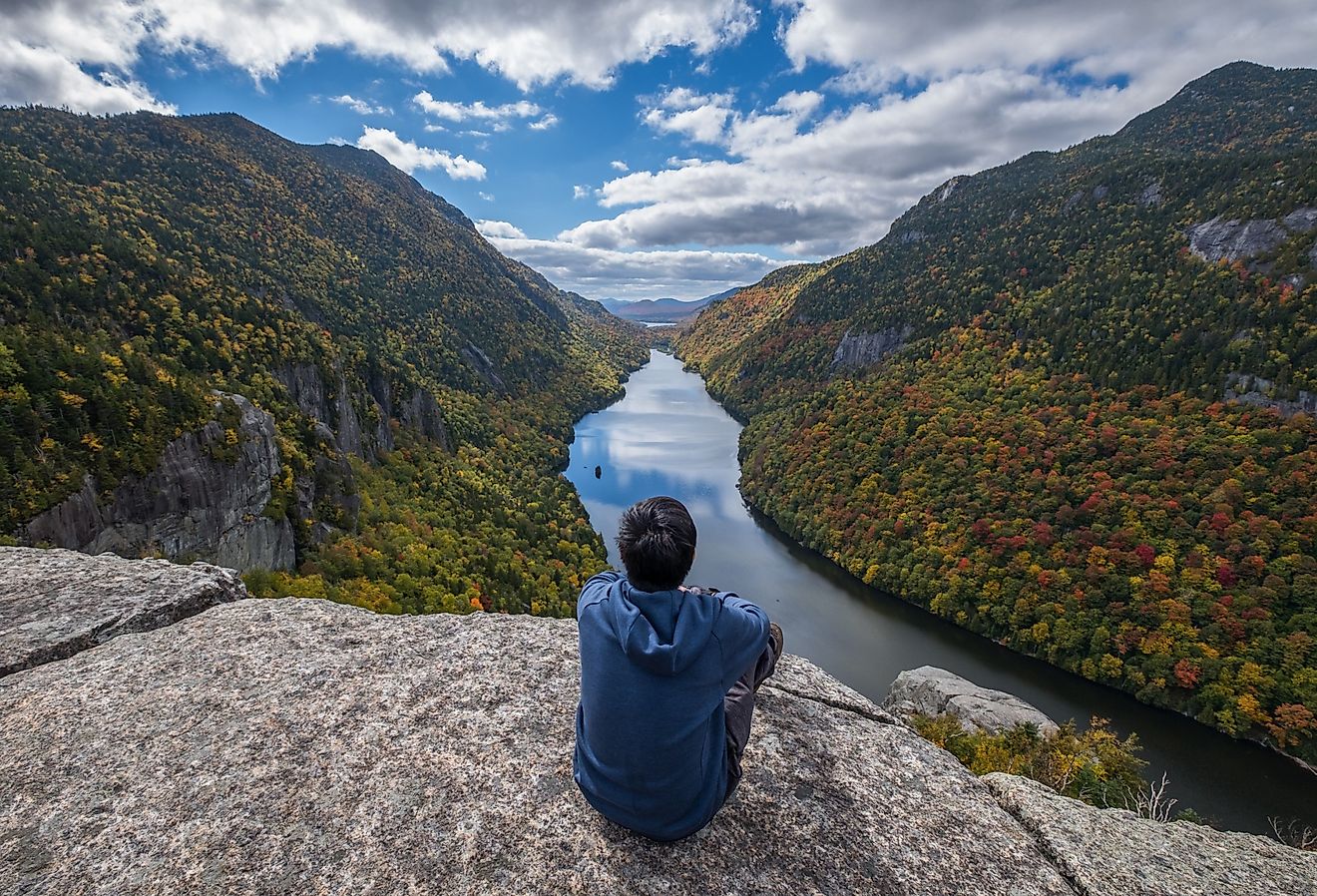 Man sitting on Indian Head Cliff at Adirondack Park, New York, USA