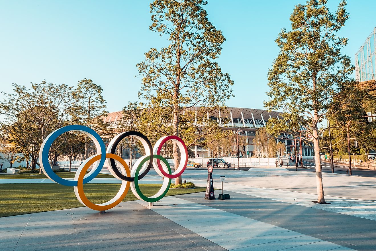 The Olympic logo in front of the Japan New National Stadium, Tokyo, Japan. Image credit: Urbanscape/Shutterstock