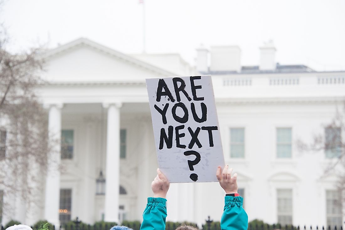 A protestor's sign at a protest against guns. Editorial credit: Rena Schild / Shutterstock.com. 