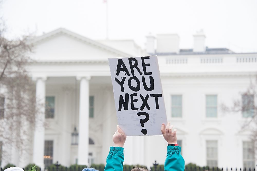 A protestor's sign at a protest against guns. Editorial credit: Rena Schild / Shutterstock.com.