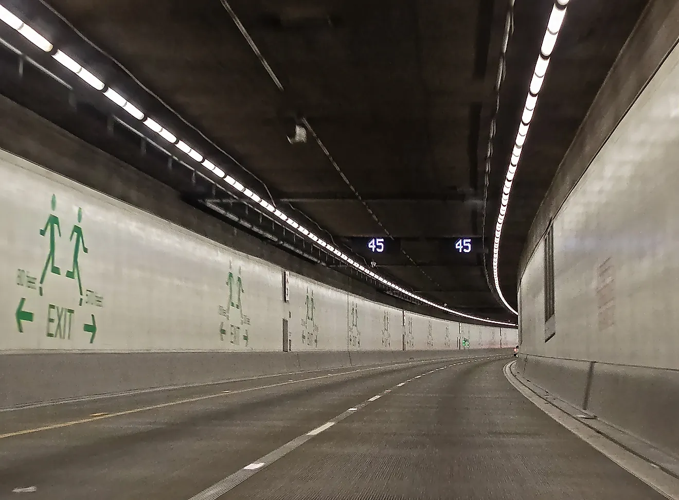 Seattle SR 99 Tunnel Interior Roadway with Curving Lanes and Emergency Exit Signs