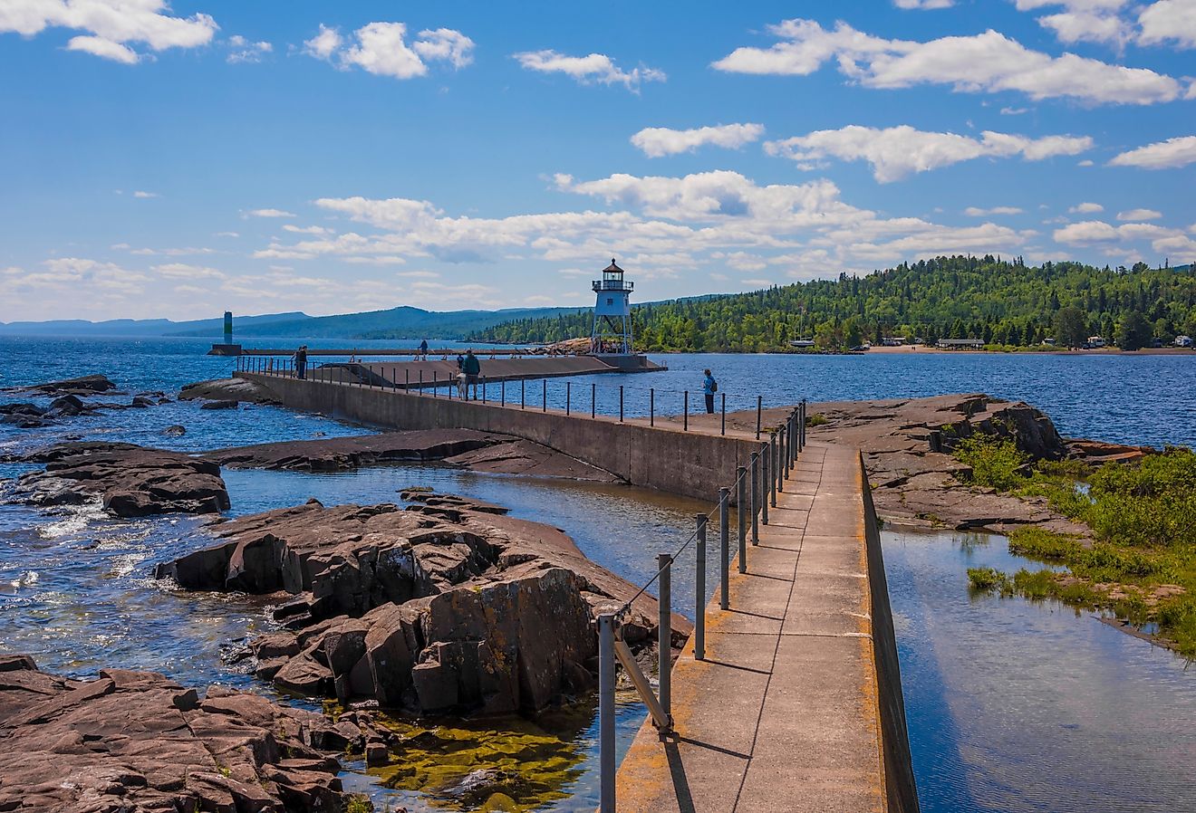 Grand Marais Lighthouse against the backdrop of the Sawtooth Mountains on Lake Superior.