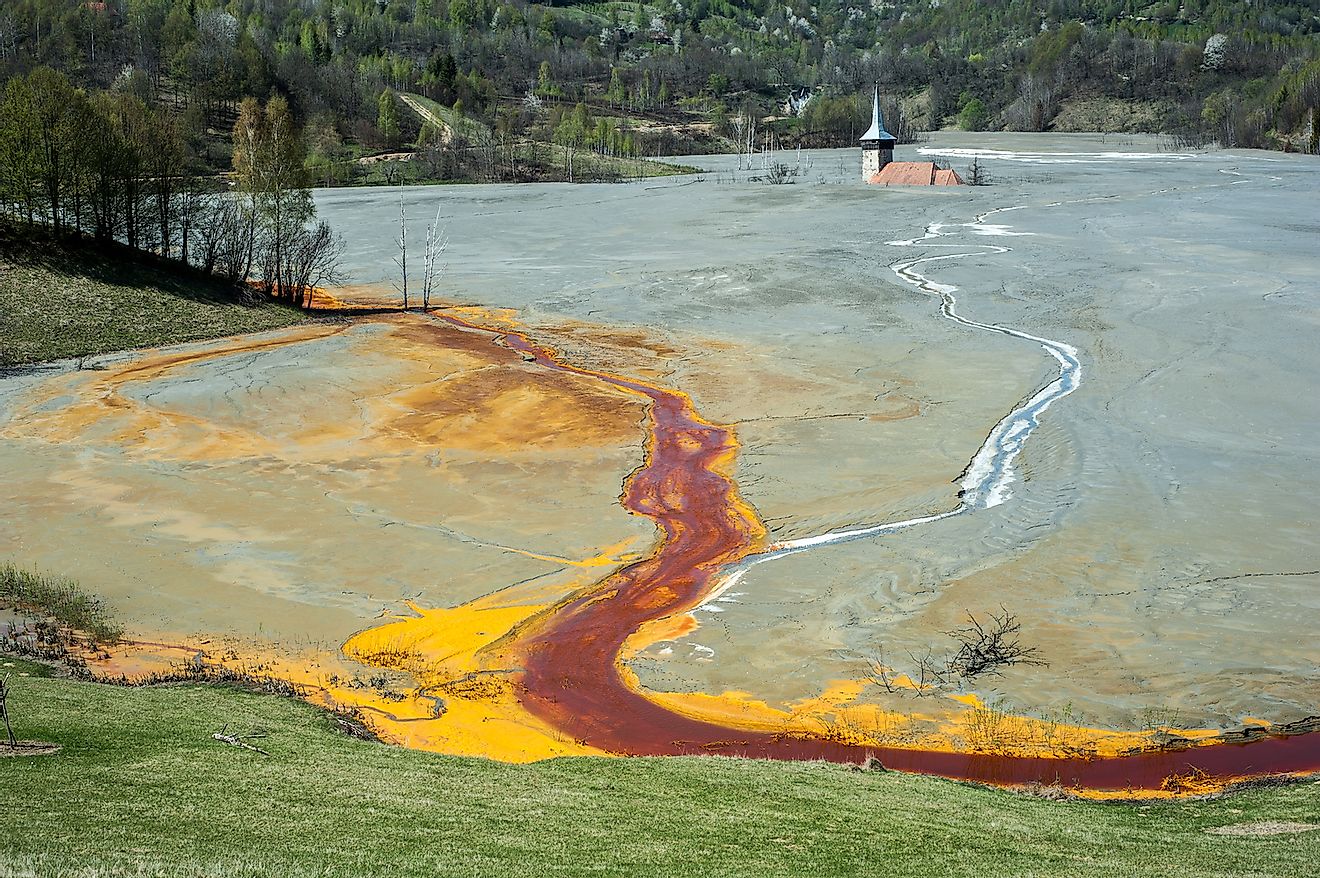 Pollution of a lake with contaminated water from a gold mine in Roșia Montană, Romania. Image credit: krstrbrt/Shutterstock.com