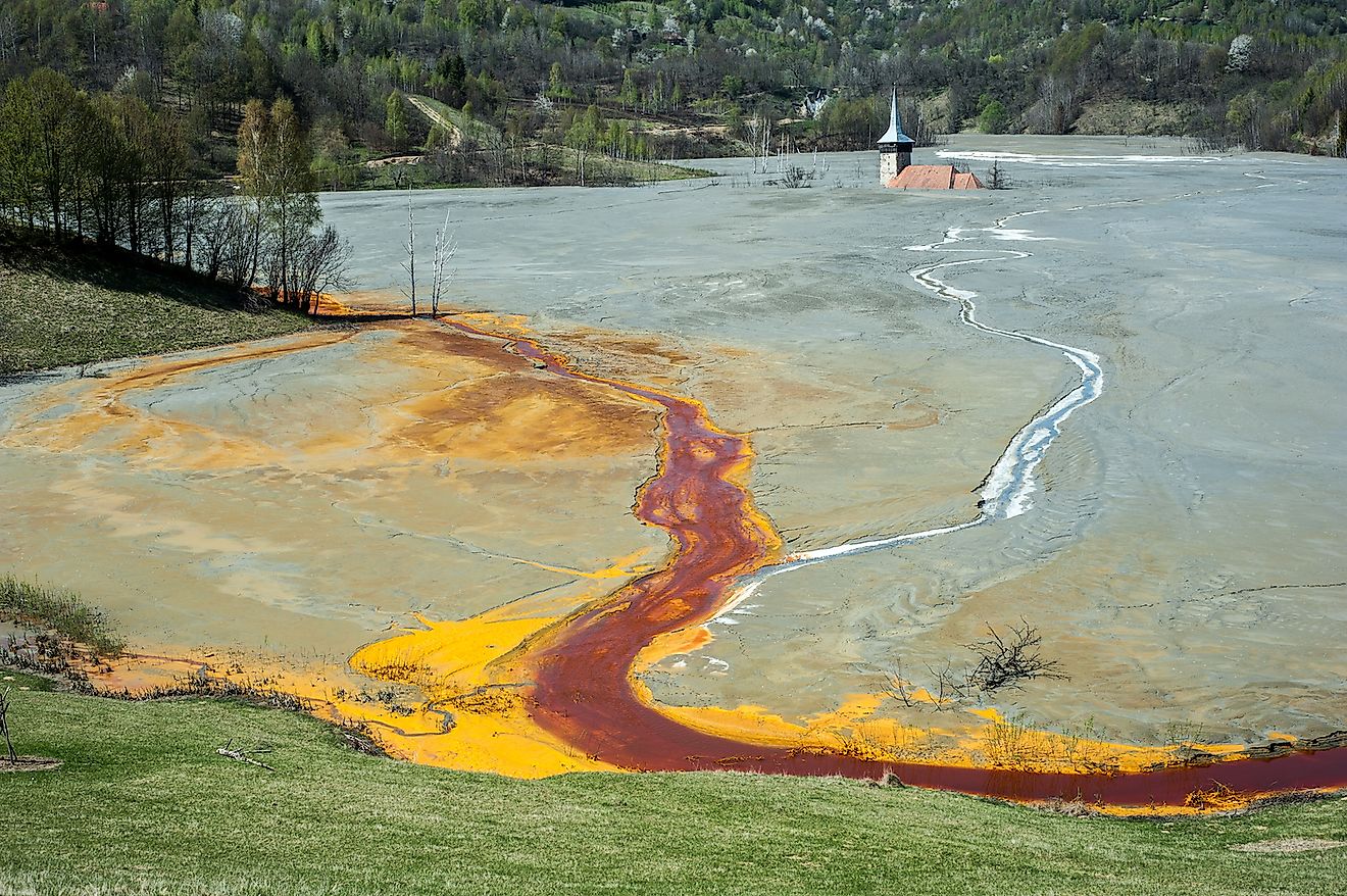 Pollution of a lake with contaminated water from a gold mine in Roșia Montană, Romania. Image credit: krstrbrt/Shutterstock.com